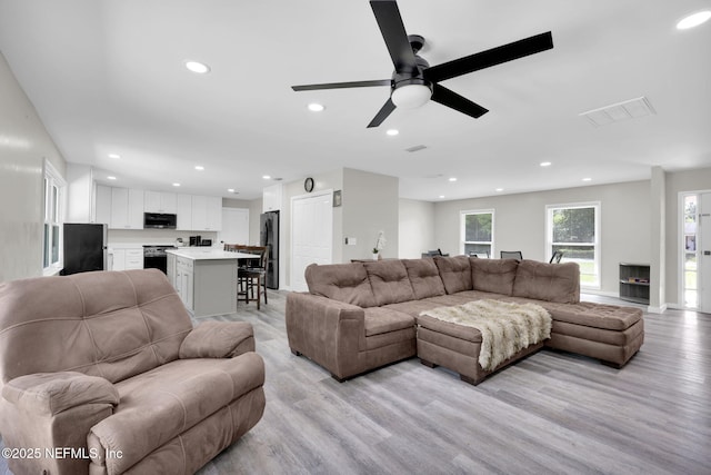 11707 Village Ln, Jacksonville, FL 32223 - living room featuring light wood-style floors, ceiling fan, and recessed lighting