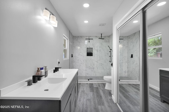11707 Village Ln, Jacksonville, FL 32223 - bathroom with vanity, recessed lighting, a marble finish shower, and wood finished floors