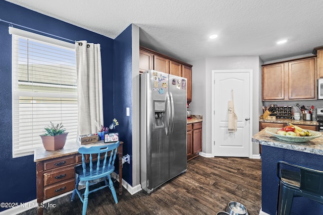 2264 Pebble Point Dr, Green Cove Springs, FL 32043 - kitchen featuring stainless steel fridge, dark wood-style floors, a textured ceiling, white microwave, and light stone counters