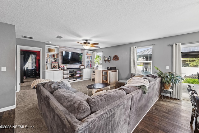 2264 Pebble Point Dr, Green Cove Springs, FL 32043 - living room with a textured ceiling, a ceiling fan, wood finished floors, radiator heating unit, and built in features
