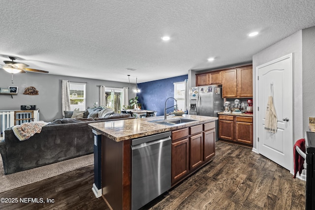 2264 Pebble Point Dr, Green Cove Springs, FL 32043 - kitchen featuring appliances with stainless steel finishes, dark wood-style flooring, a textured ceiling, an island with sink, and open floor plan