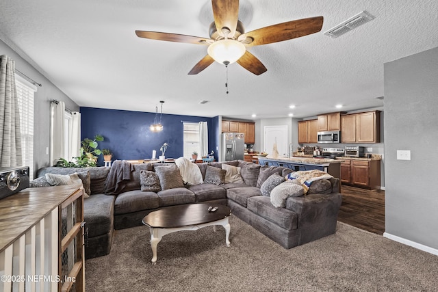 2264 Pebble Point Dr, Green Cove Springs, FL 32043 - living area with dark carpet, ceiling fan, recessed lighting, and a textured ceiling