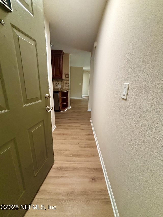 7701 Timberlin Park Blvd Unit 322, Jacksonville, FL 32256 - hall featuring light wood-style floors and a textured wall