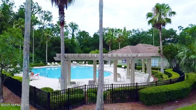 7701 Timberlin Park Blvd Unit 322, Jacksonville, FL 32256 - community pool with a patio, a pergola, and view of wooded area