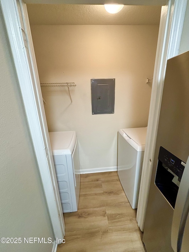 7701 Timberlin Park Blvd Unit 322, Jacksonville, FL 32256 - laundry area featuring electric panel, washing machine and dryer, and light wood-type flooring