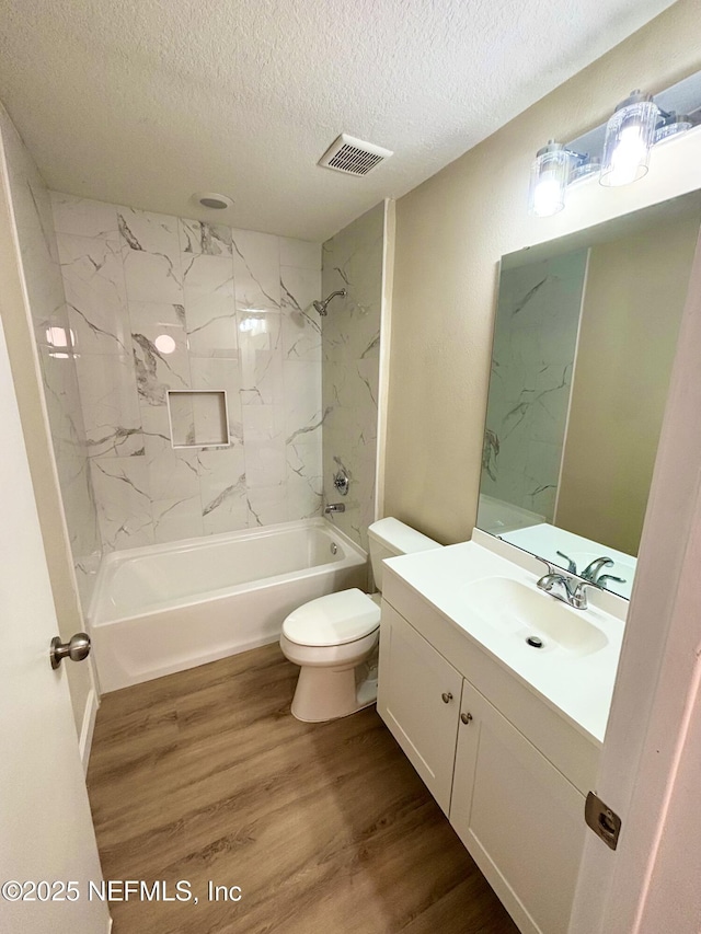 7701 Timberlin Park Blvd Unit 322, Jacksonville, FL 32256 - full bathroom with a textured ceiling, vanity, wood finished floors, and shower / washtub combination