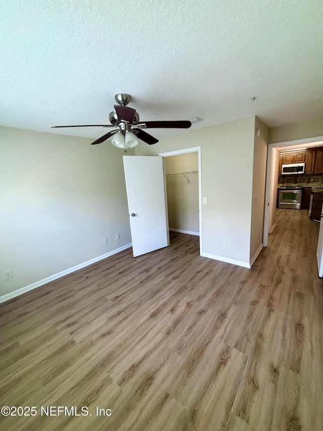 7701 Timberlin Park Blvd Unit 322, Jacksonville, FL 32256 - unfurnished living room with a ceiling fan, a textured ceiling, and light wood-type flooring