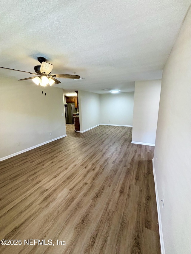 7701 Timberlin Park Blvd Unit 322, Jacksonville, FL 32256 - unfurnished living room featuring wood finished floors, a textured ceiling, and ceiling fan