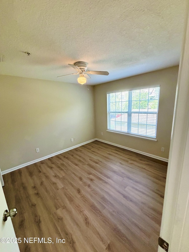 7701 Timberlin Park Blvd Unit 322, Jacksonville, FL 32256 - empty room with wood finished floors, a textured ceiling, and ceiling fan