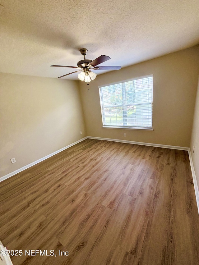 7701 Timberlin Park Blvd Unit 322, Jacksonville, FL 32256 - unfurnished room with wood finished floors, ceiling fan, and a textured ceiling