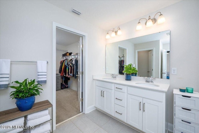 143 Dahlia Falls Dr, Saint Johns, FL 32259 - bathroom featuring double vanity, a spacious closet, and tile patterned flooring