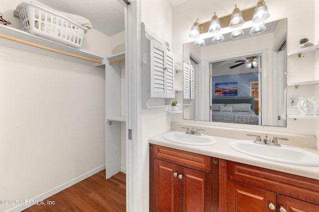 122 Twine St, Saint Augustine, FL 32084 - bathroom featuring double vanity, wood finished floors, connected bathroom, and a ceiling fan