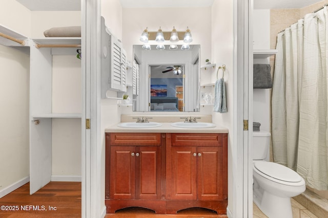 122 Twine St, Saint Augustine, FL 32084 - bathroom featuring double vanity, a ceiling fan, wood finished floors, connected bathroom, and a shower with curtain