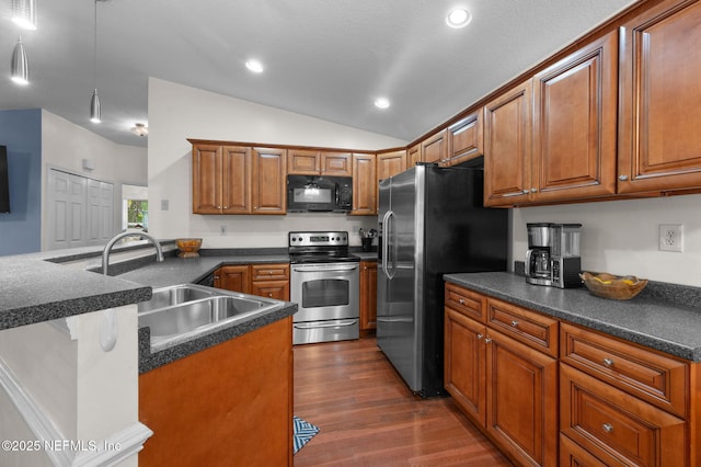 122 Twine St, Saint Augustine, FL 32084 - kitchen featuring appliances with stainless steel finishes, dark countertops, recessed lighting, brown cabinetry, and lofted ceiling