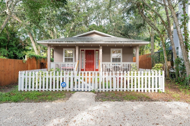122 Twine St, Saint Augustine, FL 32084 - bungalow-style house with covered porch, a fenced front yard, and roof with shingles