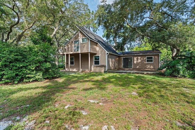 1083 Kings Rd, Neptune Beach, FL 32266 - back of house featuring a lawn
