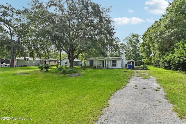 2259 Marlee Rd S, Jacksonville, FL 32259 - manufactured / mobile home featuring driveway, a front lawn, and a carport