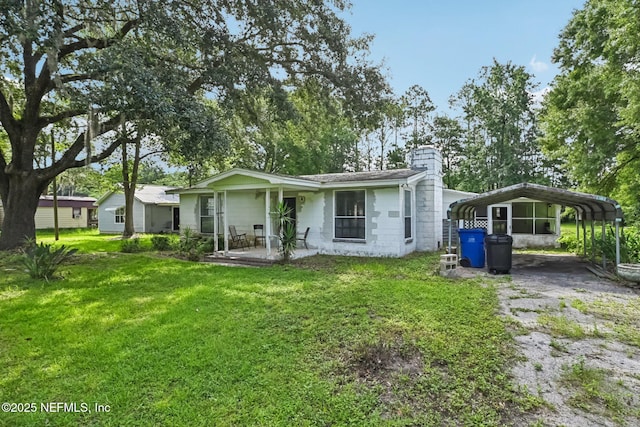2259 Marlee Rd S, Jacksonville, FL 32259 - rear view of house with a yard, a chimney, a carport, covered porch, and driveway