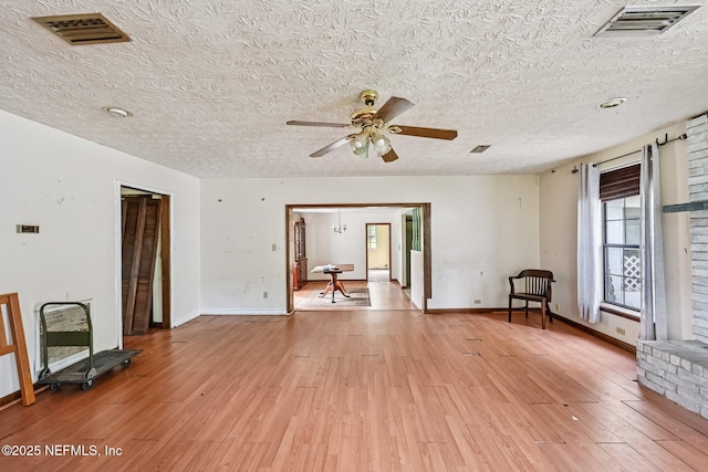 2259 Marlee Rd S, Jacksonville, FL 32259 - unfurnished living room featuring light wood-type flooring, ceiling fan, and a textured ceiling