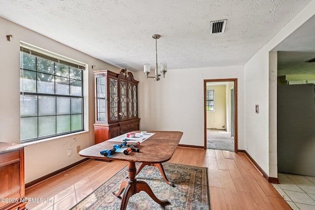 2259 Marlee Rd S, Jacksonville, FL 32259 - dining space featuring light wood finished floors, a chandelier, and a textured ceiling