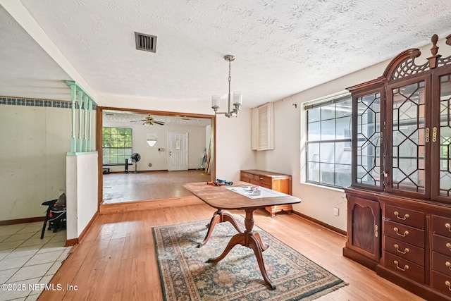 2259 Marlee Rd S, Jacksonville, FL 32259 - dining room with light wood-style flooring, a textured ceiling, and a chandelier