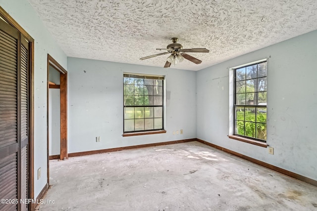 2259 Marlee Rd S, Jacksonville, FL 32259 - unfurnished bedroom with multiple windows, concrete flooring, a textured ceiling, and a ceiling fan