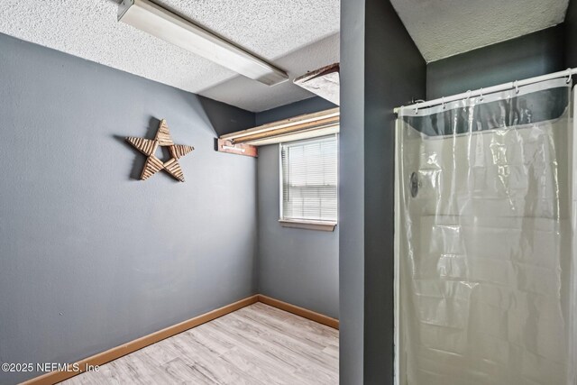 2259 Marlee Rd S, Jacksonville, FL 32259 - bathroom with wood finished floors, a textured ceiling, and a shower with shower curtain