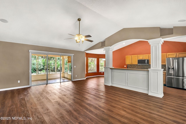 1994 Protection Pt, Fleming Island, FL 32003 - unfurnished living room with decorative columns, ceiling fan, vaulted ceiling, dark wood-style flooring, and arched walkways