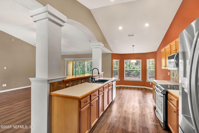 1994 Protection Pt, Fleming Island, FL 32003 - kitchen with appliances with stainless steel finishes, lofted ceiling, decorative columns, dark wood-style floors, and light countertops