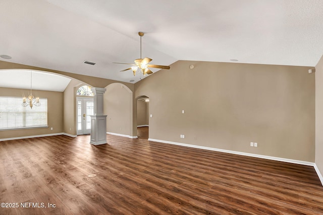 1994 Protection Pt, Fleming Island, FL 32003 - unfurnished living room with a ceiling fan, arched walkways, vaulted ceiling, dark wood-type flooring, and a chandelier