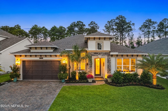95196 Golden Glow Dr, Fernandina Beach, FL 32034 - mediterranean / spanish-style home with stucco siding, a garage, stone siding, decorative driveway, and a lawn