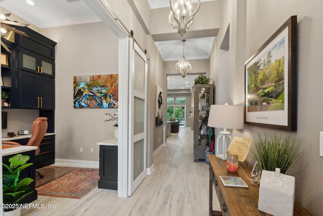 95196 Golden Glow Dr, Fernandina Beach, FL 32034 - home office featuring a chandelier, a barn door, and light wood-style floors