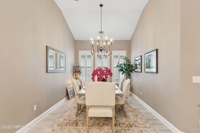 95196 Golden Glow Dr, Fernandina Beach, FL 32034 - dining space featuring a chandelier, light wood-style flooring, and lofted ceiling