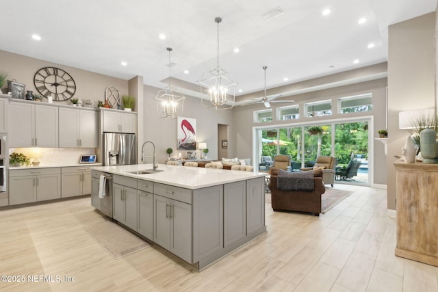 95196 Golden Glow Dr, Fernandina Beach, FL 32034 - kitchen with appliances with stainless steel finishes, gray cabinetry, light countertops, open floor plan, and recessed lighting
