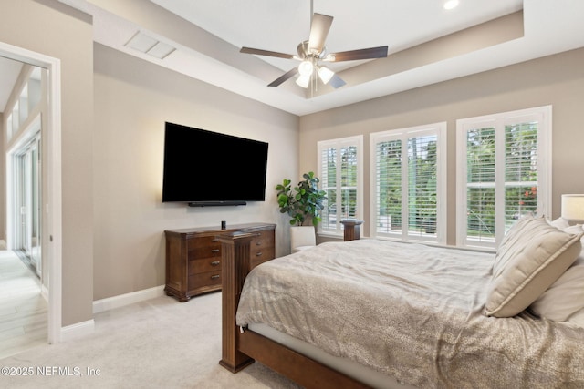 95196 Golden Glow Dr, Fernandina Beach, FL 32034 - bedroom with a raised ceiling, light colored carpet, and a ceiling fan