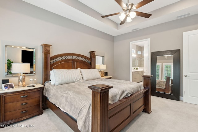 95196 Golden Glow Dr, Fernandina Beach, FL 32034 - bedroom with light carpet, a raised ceiling, ensuite bath, and ceiling fan