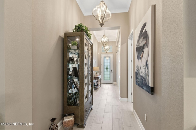 95196 Golden Glow Dr, Fernandina Beach, FL 32034 - hallway with a chandelier and a textured wall