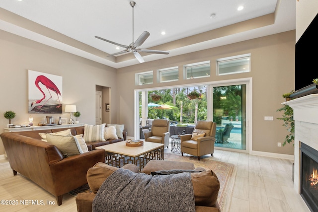 95196 Golden Glow Dr, Fernandina Beach, FL 32034 - living area featuring a tile fireplace, a ceiling fan, recessed lighting, a high ceiling, and light wood-style flooring