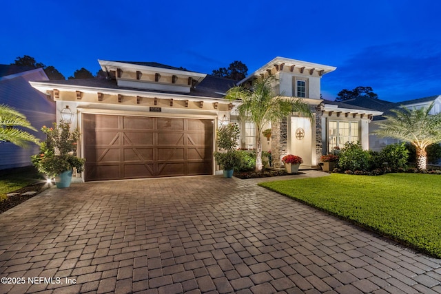 95196 Golden Glow Dr, Fernandina Beach, FL 32034 - view of front facade with decorative driveway, stucco siding, a garage, and a yard