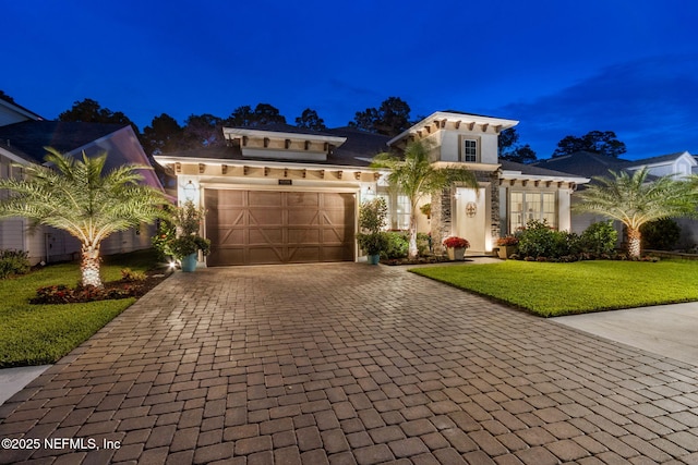 95196 Golden Glow Dr, Fernandina Beach, FL 32034 - view of front facade with decorative driveway, an attached garage, a yard, and stucco siding