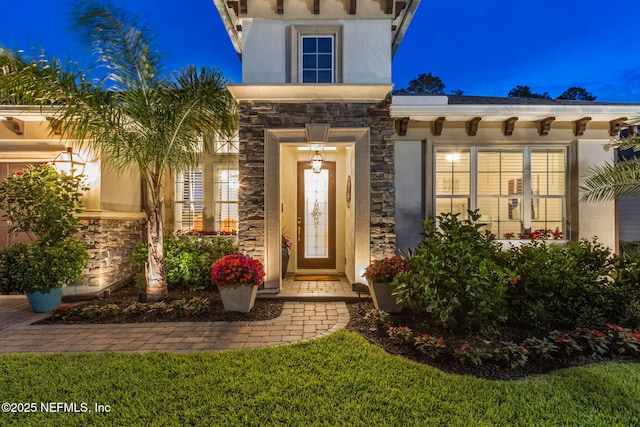 95196 Golden Glow Dr, Fernandina Beach, FL 32034 - exterior entry at twilight with stone siding and stucco siding