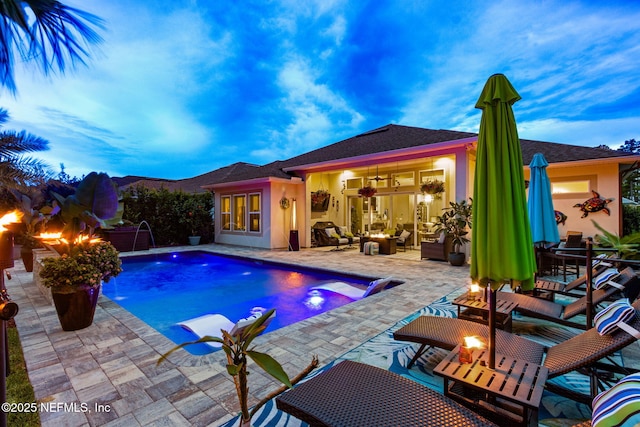 95196 Golden Glow Dr, Fernandina Beach, FL 32034 - swimming pool featuring a patio area and an outdoor living space with a fire pit
