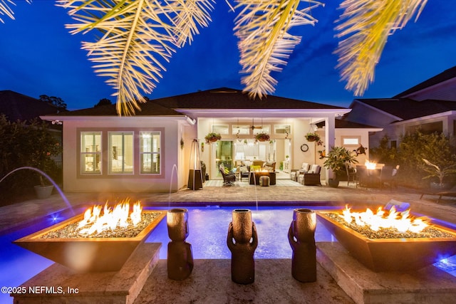 95196 Golden Glow Dr, Fernandina Beach, FL 32034 - pool at twilight featuring a storage structure, an outbuilding, a patio area, an outdoor living space with a fire pit, and an outdoor pool