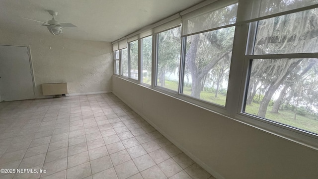 2664 SW 14th Dr Unit 325, Gainesville, FL 32608 - unfurnished sunroom featuring a textured wall and baseboards