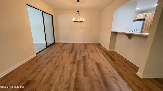2664 SW 14th Dr Unit 325, Gainesville, FL 32608 - unfurnished dining area featuring wood finished floors and a chandelier