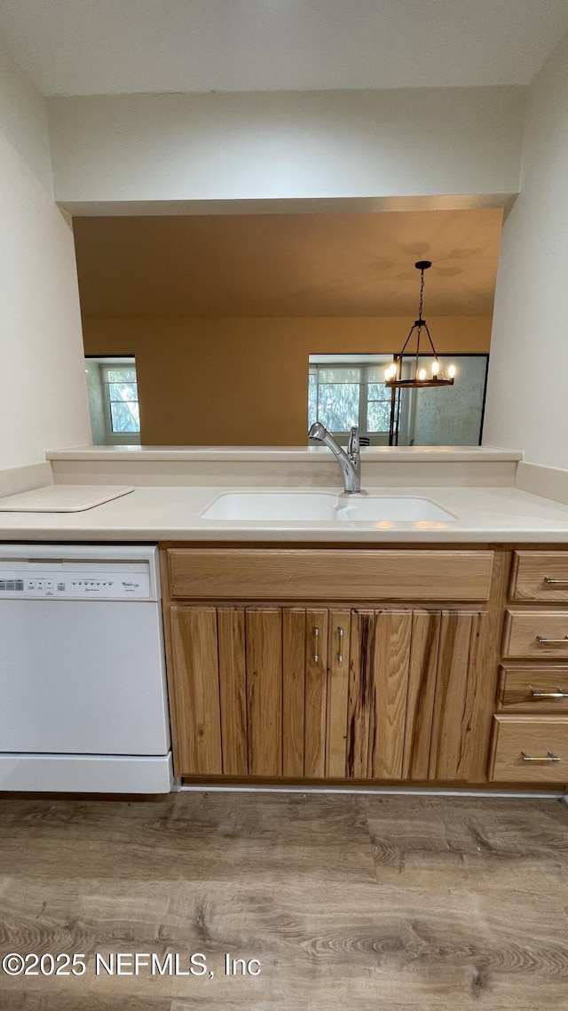 2664 SW 14th Dr Unit 325, Gainesville, FL 32608 - kitchen with white dishwasher, wood finished floors, brown cabinets, and light countertops