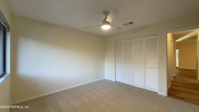 2664 SW 14th Dr Unit 325, Gainesville, FL 32608 - unfurnished bedroom featuring a closet, carpet flooring, and a ceiling fan