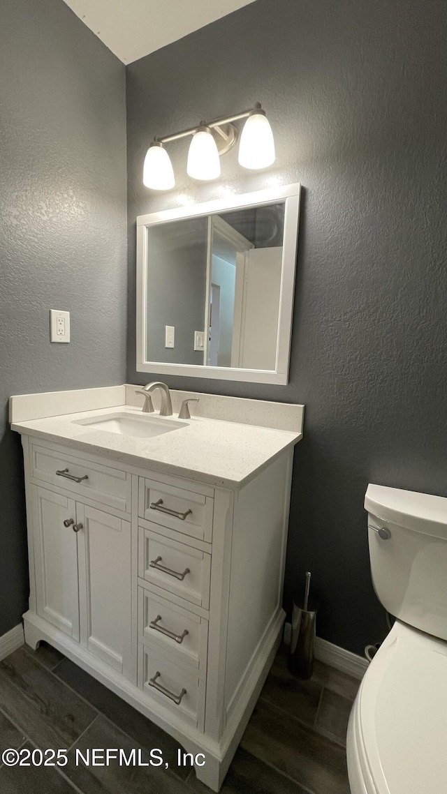2664 SW 14th Dr Unit 325, Gainesville, FL 32608 - bathroom featuring vanity, wood finished floors, and a textured wall