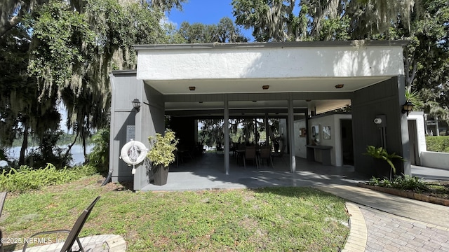 2664 SW 14th Dr Unit 325, Gainesville, FL 32608 - view of front of house featuring a front yard and a patio area