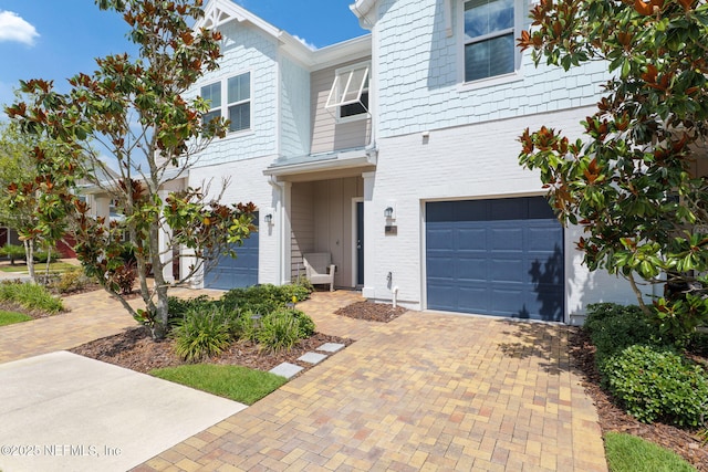 30 Yeti Ct, Saint Augustine, FL 32092 - townhome / multi-family property with an attached garage, decorative driveway, and brick siding